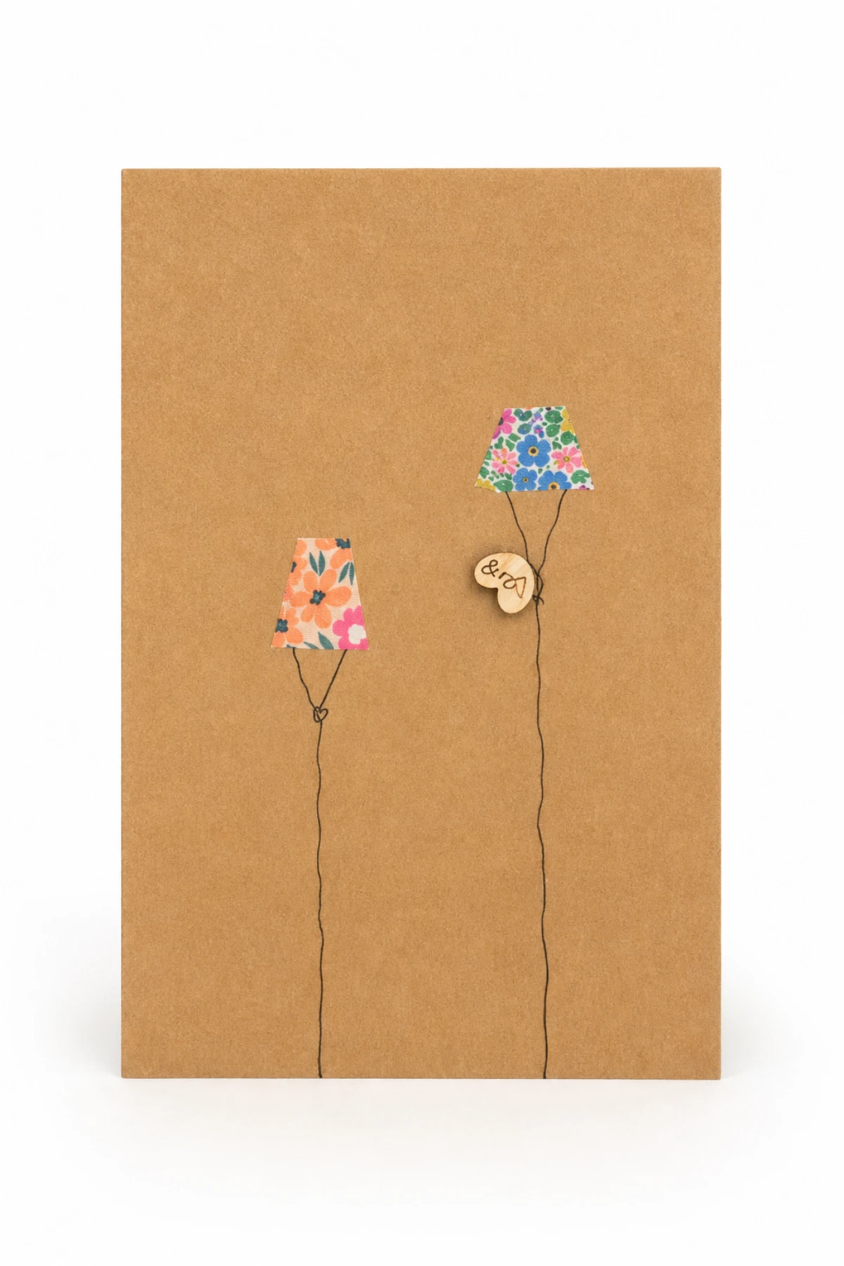Kraft handmade greeting card with two floral kites and a wooden heart