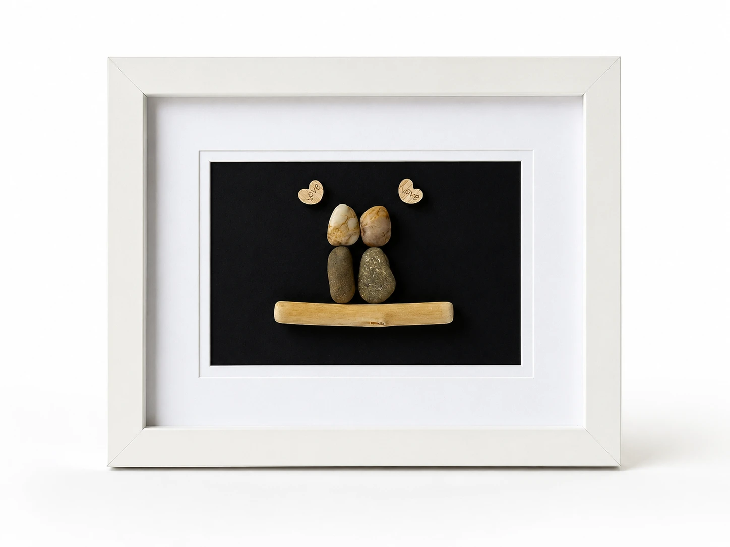 Colourful pebble family artwork with ceramic stone bodies